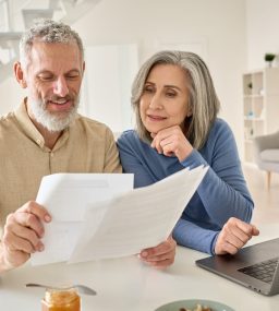 Middle,Aged,Senior,Old,Couple,Holding,Documents,Reading,Paper,Bills