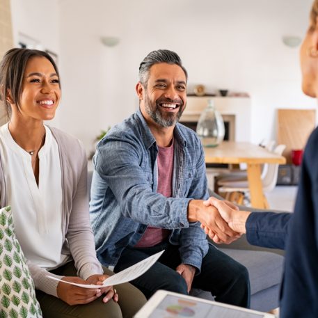 Mature,Indian,Man,Shaking,Hands,With,Financial,Advisor,At,Home.